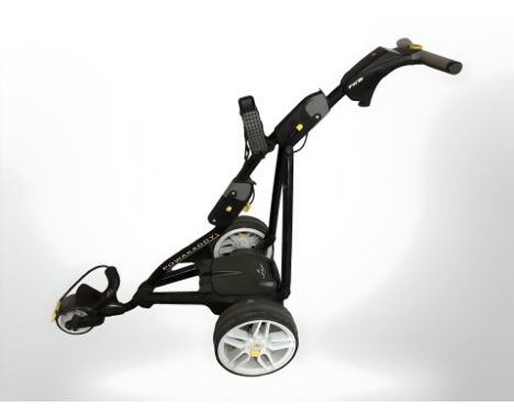 A Powakaddy electric golf caddy with battery pack and charger 