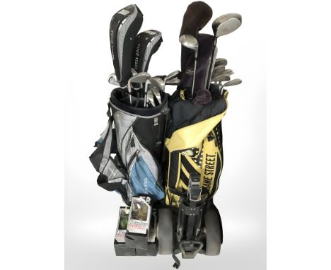 Two golf bags containing assorted iron and drivers including Taylormade, Zucci etc, together with golf bag trolley, Dunlop cl