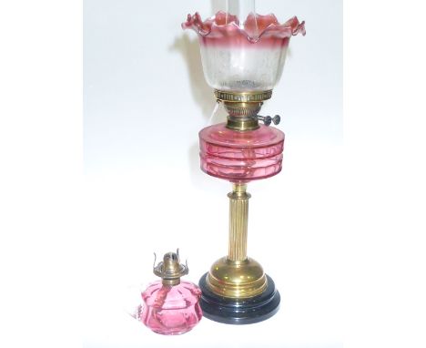 Victorian brass column oil lamp with ruby glass reservoir and etched ruby tinted shade and a small ruby glass chamber oil lam