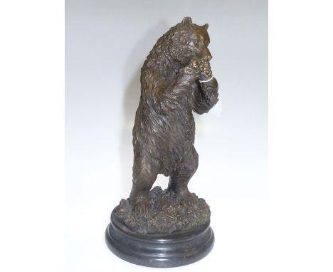 Patinated metal model of a bear eating grapes