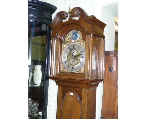 Antique oak eight day longcase clock, having arched brass and silvered moon phase dial