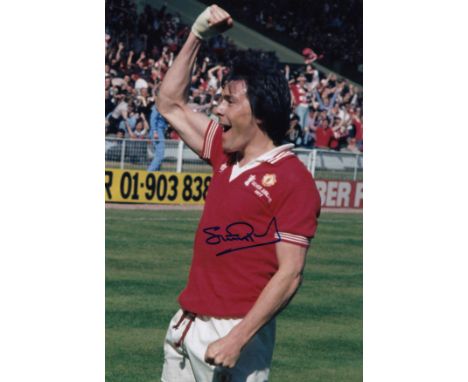 Football Autographed Stuart Pearson 12 X 8 Photo: Col, Depicting Manchester United Striker Stuart Pearson Punching The Air In