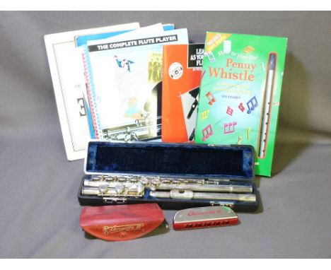 A LAFLEUR MODEL 82990, CASED FLUTE, a M Hohner Chrometta 10 harmonica along with a quantity of music books