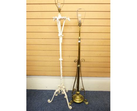 A VICTORIAN BRASS EXTENDING STANDARD LAMP and a painted wrought iron example with dragon head detail