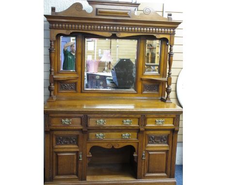 A WELL PRESENTED EDWARDIAN CARVED OAK MIRROR BACK SIDEBOARD, the triple mirror top with architectural detail over a dog kenne