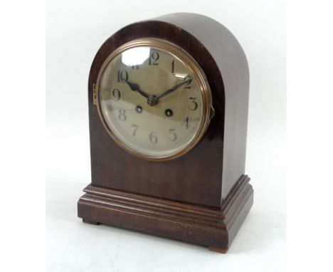 A 20th century mantle clock in domed mahogany case, eight day movement, the dial with Arabic numerals, striking on a coil, 21