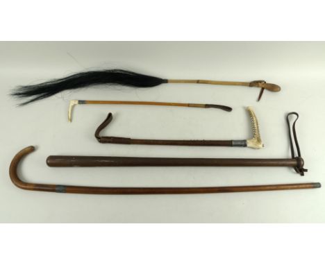 A group of five vintage sticks and riding crops, one of turned oak with leather loop attached, possibly a night stick or for 