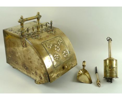 An Arts and Crafts brass coal scuttle, with lid secured with copper rivets, 27.5 by 42 by 38cm, complete with poker, 24cm, sh