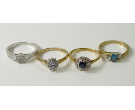 A collection of four rings comprising an 18ct gold Art Deco ring set with set with round cut sapphire encircled by diamond ch