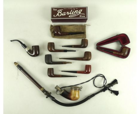 A collection of early to mid 20th century pipes including an unusual long stemmed German pipe, the carved horn knopped mouth 