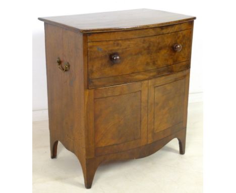 An 19th century mahogany bow fronted commode, with turned handles to lift lid and front, enclosing a white ceramic bowl, bras