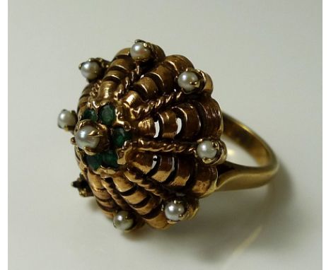 An unusual 9ct gold scalloped ring set with seed pearls and six emeralds, one pearl missing, size M, 8.8g.Provenance: The Pri