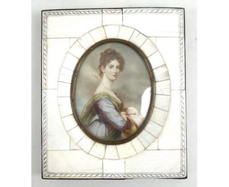 A 19th century portrait miniature, painted on ivory, depicting a half length portrait of a lady in a blue gown, with a green 