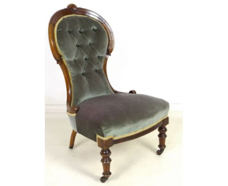 A Victorian mahogany nursing chair, circa 1890, with carved and moulded rail, rosette motifs, the buttoned back upholstered i