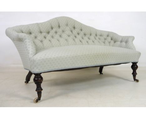 A small Victorian two seater settee, with shaped camel back curving into out swept arms, upholstered with button back in pale