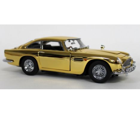 A 1/24 scale 22 carat gold plated die cast and ABS plastic replica model Aston Martin DB5, by Danbury Mint, Special Edition, 