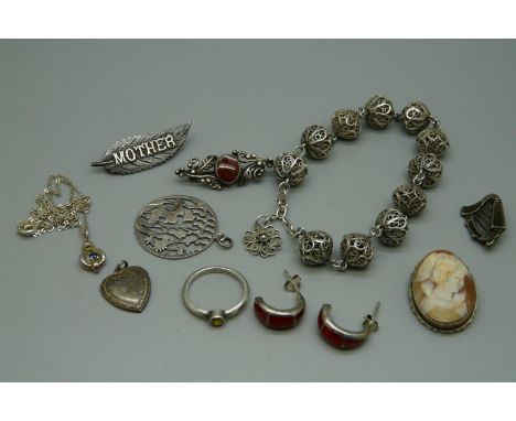 Four silver brooches, two silver pendants, a silver ring, silver earrings, a silver necklace and a silver bracelet, harp broo