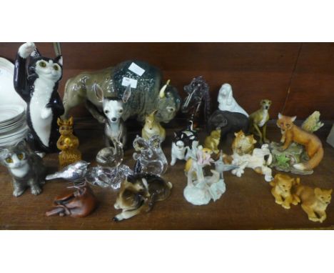 A collection of ceramic and glass animal figures including bison, kangaroo and joey, fawn, chihuahua, etc. 