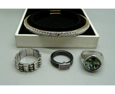A Swarovski bangle, a titanium and diamond ring and two designer rings, Swatch and Aurora 