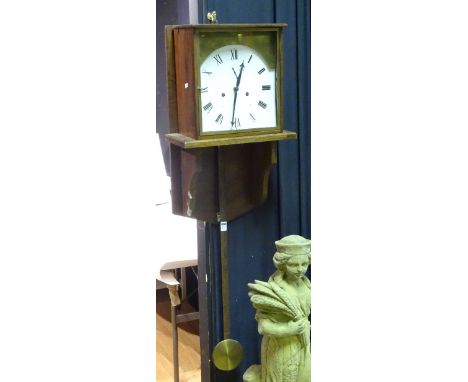 A large oak wall clock, with weight and pendulum, the white enamel dial with Roman numerals and subsidiary seconds dial, in s