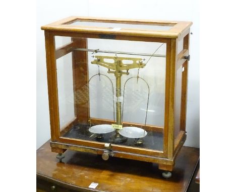 A set of chemistry scales by Thomson Skinner & Hamilton Glasgow, in glazed case, named L Oertling Ltd, London on brass scales