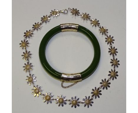 A green jade coloured bangle, with gold plated mounts, together with a silver daisy necklace, stamped 925, 37cm long (2)