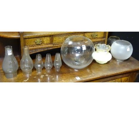 A collection of oil lamp funnels and bowls, together with a Victorian foliate door handle (9)