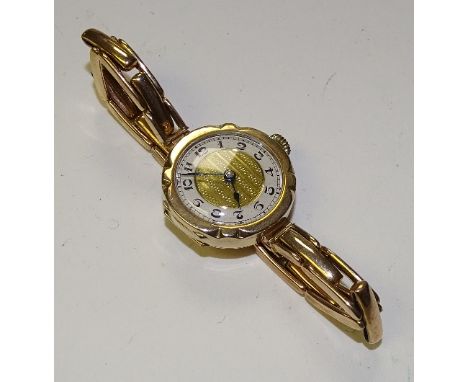 A 9ct gold lady's cocktail watch, the champagne engine turned dial with white enamel chapter ring and Arabic numerals, on ela