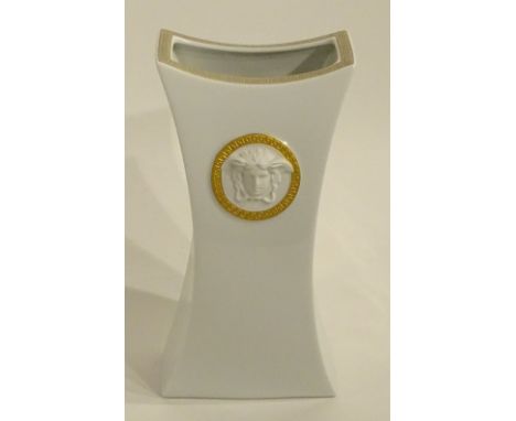 A Versace white ceramic vase by Rosenthal, decorated with moulded relief Versace emblem masks, label to underside, 25cm high