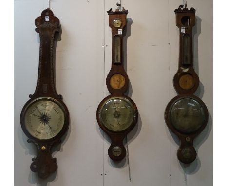 A 19th century rosewood wheel barometer, signed WM Gilbert, 15cm high, St Belfast to silvered dial, lacking mercury/thermomet