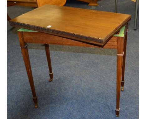 A mahogany fold over card table circa 1930's, the fold over top enclosing green felt lined interior, raised on tapering suppo