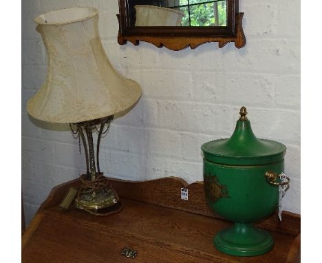 An antique gilt metal table lamp with shade, decorated with rams head terminals, converted to electricity, 29cm high, togethe