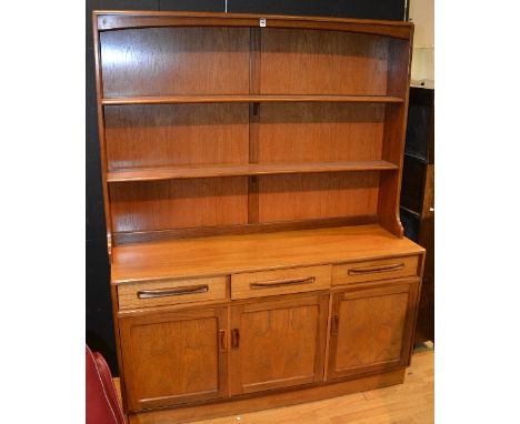 A retro G-plan teak dresser, with two tier shelf rack above three small drawers and three panelled doors, 178cm high x 142cm 