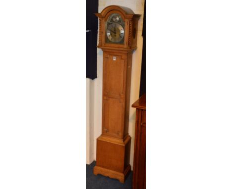 An oak Granddaughter clock signed Tempus Fugit circa 1930's, the arched dial with glazed door enclosing silvered and gilded d