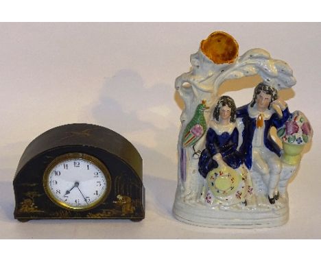 An Edwardian black japanned mantel clock, the white enamel dial with Arabic numerals, decorated with panels of figures in fol