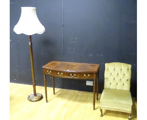 A reproduction side table, with central drawer flanked with a small drawer, raised on reeded supports, 74cm high x 103cm wide