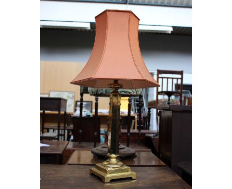 A modern brass table lamp with shade