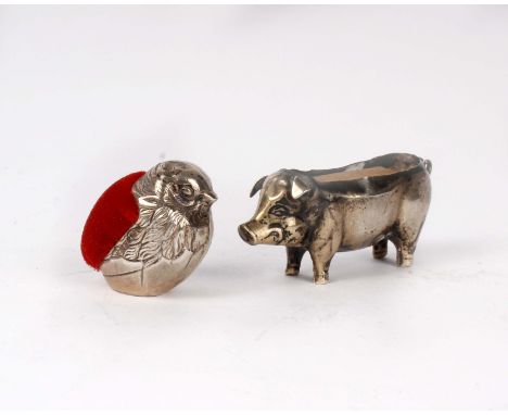 Two sterling silver pin cushions, a model of a pig by Henry Matthews, Birmingham 1911 (vacant cushion) and a bird, London 197