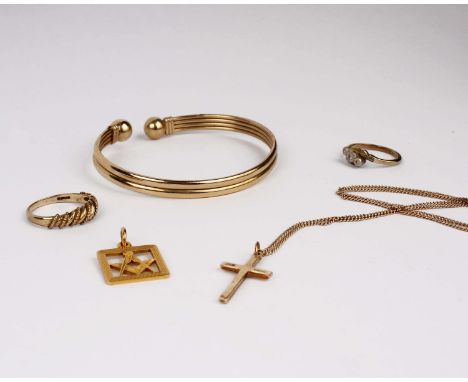 A collection of 9ct gold items to include a bangle, rings and a crucifix pendant. 20g gross.