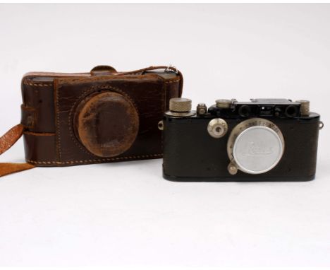 A 1970's 35 MM SLR camera by Petri together with two other leather cased cameras 