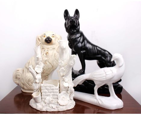 A large black pottery model of a German Shepard together with a Staffordshire flat back model of a Spaniel, a blanc de chine 