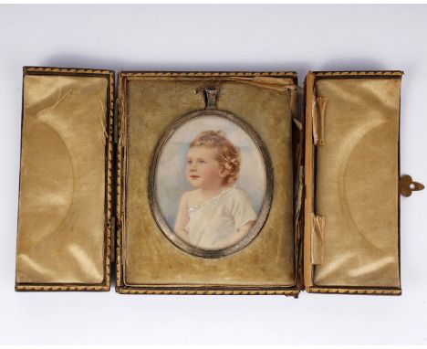 A late 19th early 20th century miniature portrait of a young child in oval brass frame and original leather bound box/display