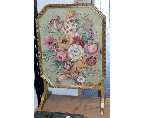 A GILT FIRE SCREEN WITH FLORAL DECORATION     
