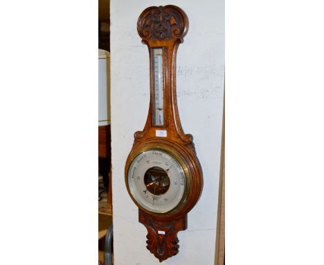 AN OAK CASED COMBINATION BAROMETER THERMOMETER BY HUGHES &amp; SONS, LONDON     