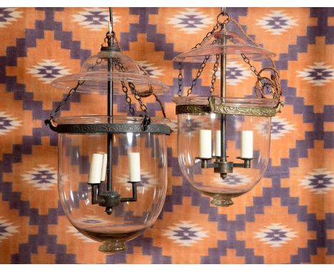 A near pair of clear glass mosque lanterns  20th century, each with three light fittings, 23cm diameter 40cm highTogether wit