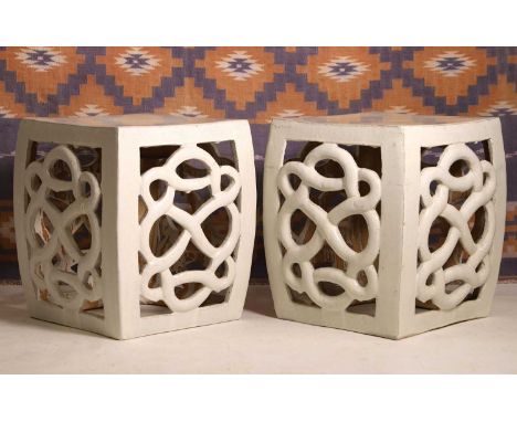 A pair of Chinese pottery garden seats 20th century, of scrolled design, in a white glaze36cm square47cm high (2)Condition Re