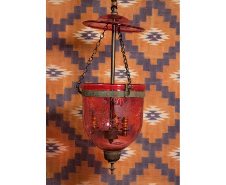 A cranberry glass mosque lantern 19th century, engraved with cut fruiting vine decoration, to a three light fitting,20cm diam