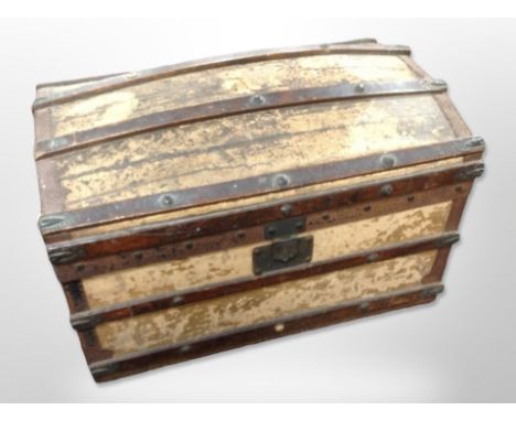 A 19th century canvas and wooden bound domed top trunk, width 70 cm (Af) CONDITION REPORT: Hinges loose, woodworm damage etc 