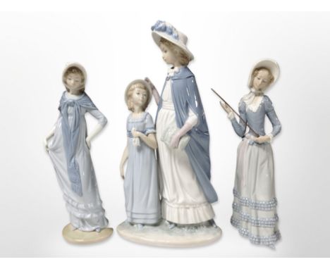 A Lladró figure of a lady holding a cane, a Nao figure and a Nao figure group, tallest 37cm.