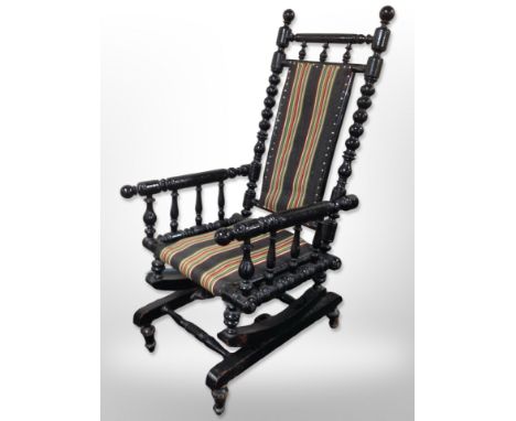 A 20th century Scandinavian bobbin turned ebonised rocking chair